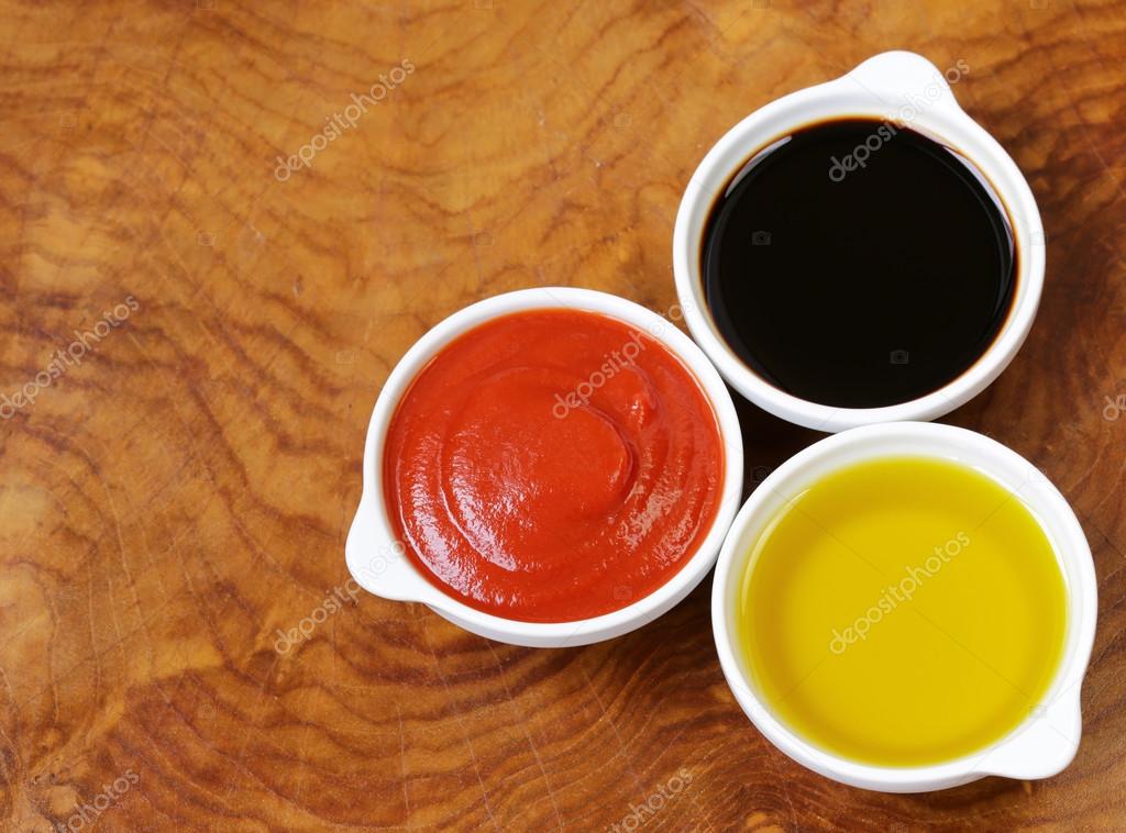 Traditional Italian sauces balsamic vinegar, tomato sauce and olive oil Stock Photo by