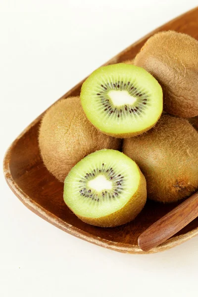 Organic kiwi fruit on wooden plate — Stock Photo, Image