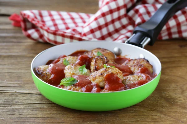 Fried small meatballs in tomato sauce with basil — Stock Photo, Image