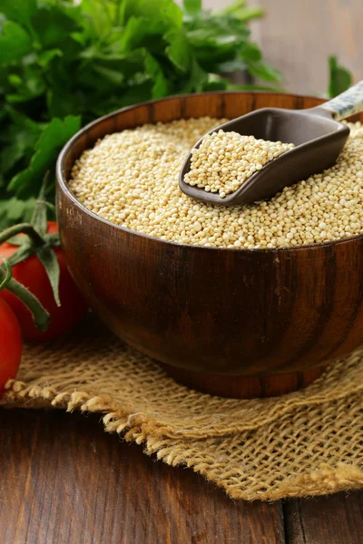 Natural organic cereal quinoa on a wooden table — Stock Photo, Image