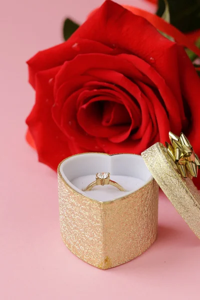 Red rose flower with a gold ring with a diamond — Stock Photo, Image
