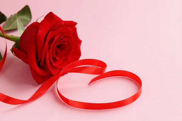 Red rose flower with a ribbon in the form of heart Stock Image