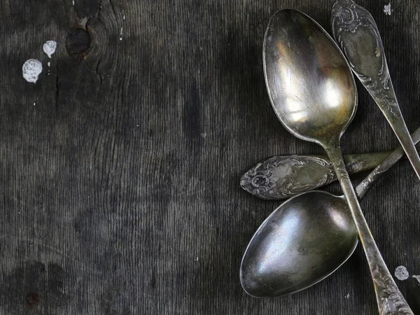 Vintage silver spoons on a wooden background — Stock Photo, Image