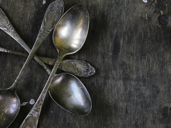 Vintage silver spoons on a wooden background — Stock Photo, Image