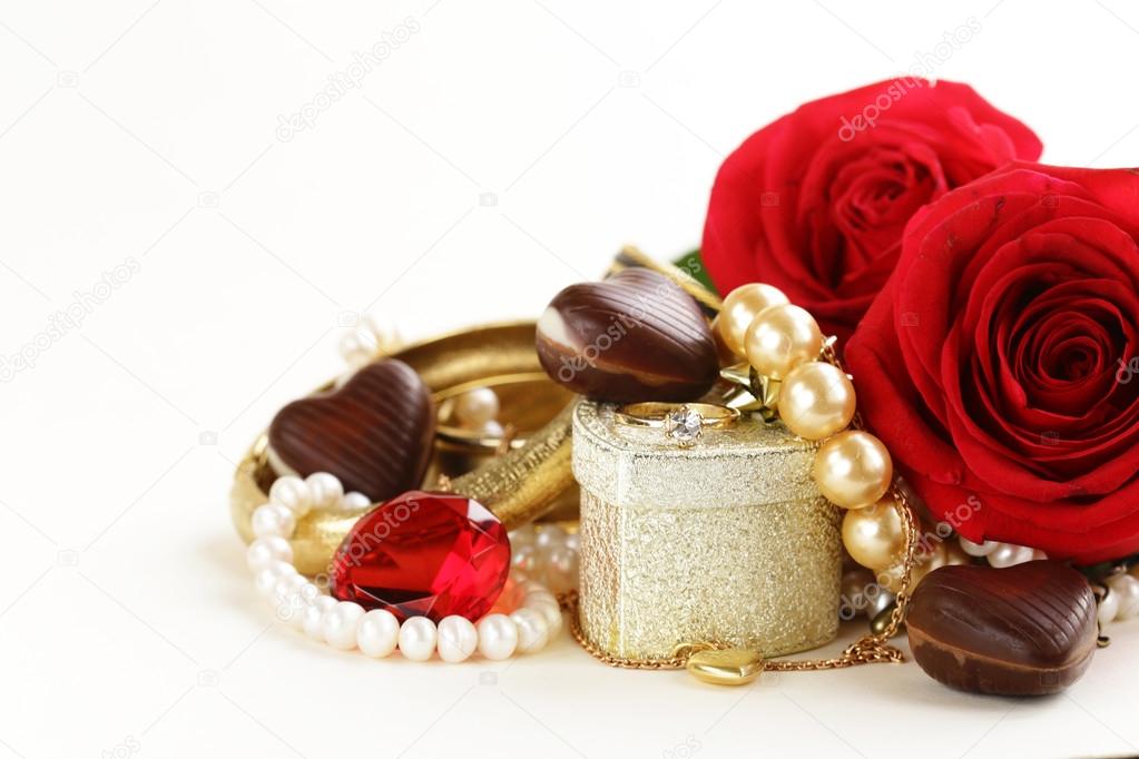 gold jewelry (pearls, necklace, ring) with roses on a white background