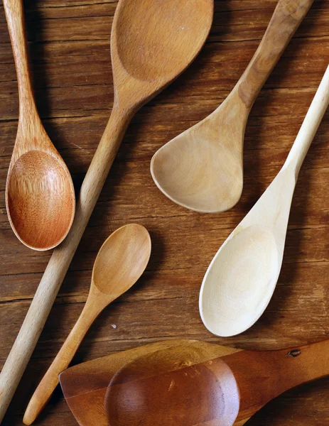 Empty wooden spoons on an old grungy background — Stock Photo, Image