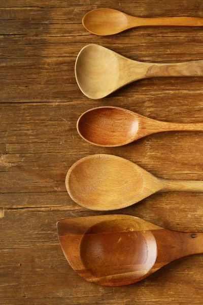 Empty wooden spoons on an old grungy background — Stock Photo, Image