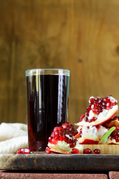 Natuurlijke granaatappelsap op een houten tafel — Stockfoto