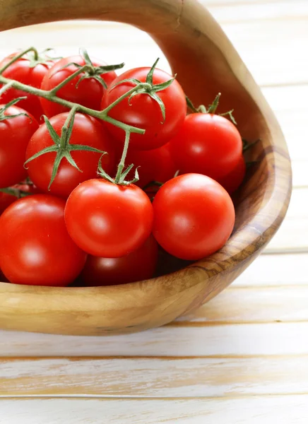 Fresh ripe red tomatoes in a wooden bowl — Stock Photo, Image