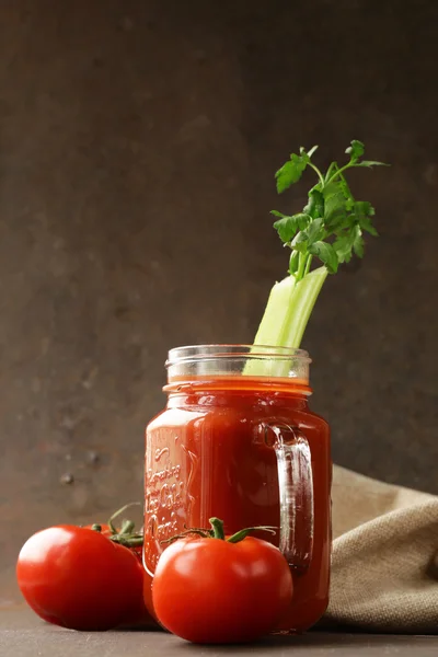 Fresh tomato juice in a glass jar on the table — Stock Photo, Image