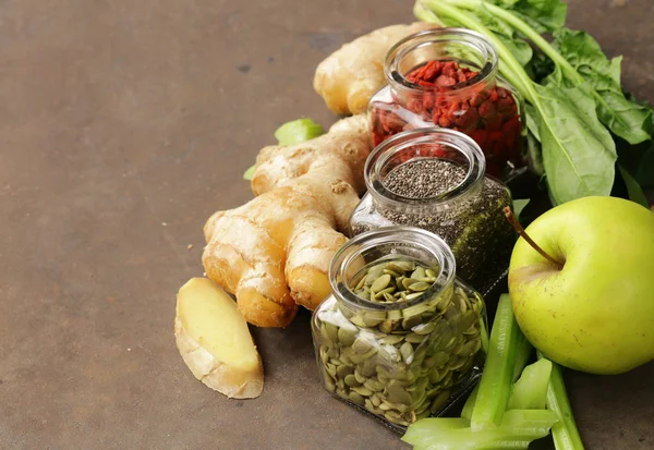 Super food - goji berries, chia seeds and pumpkin seeds with vegetables, fruits and herbs