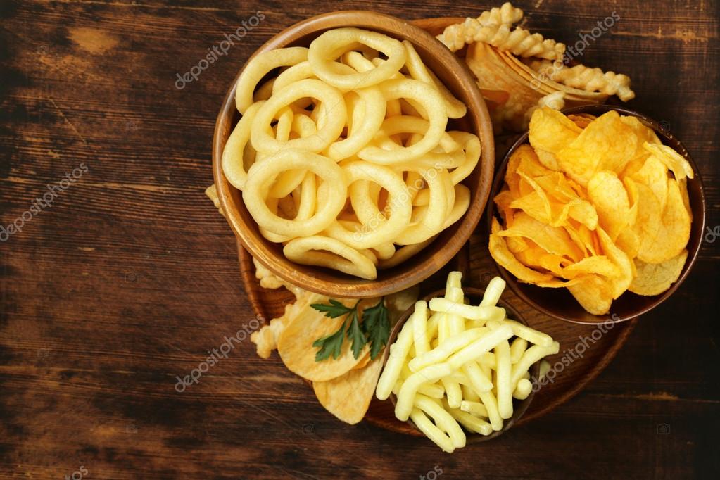 Assorted different kinds of chips onion rings, sticks and flat Stock