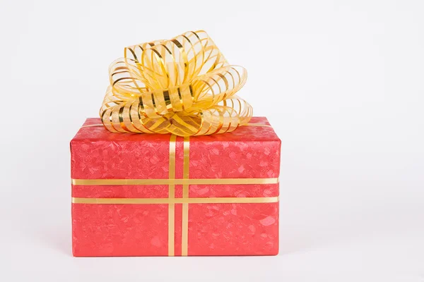 Single red gift box with gold ribbon .