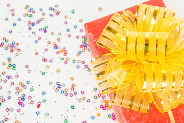 Caja de regalo roja con cinta de oro y lazo . — Foto de Stock