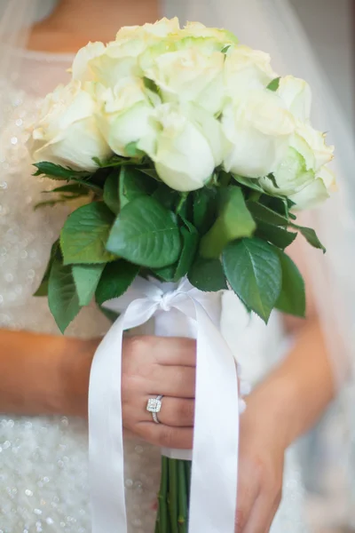 Une belle mariée avec des roses blanches à la main . — Photo