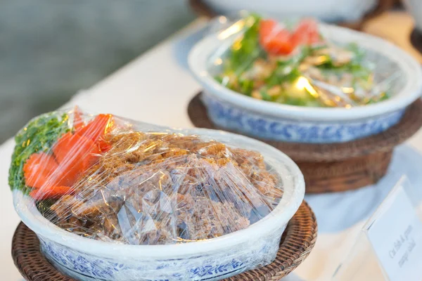 Spicy fish in a bowl with the plastic wrap. — Stock Photo, Image