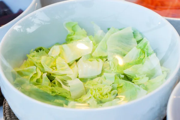 Vegetables in a glass bowl on the plastic wrap. — Stock Photo, Image