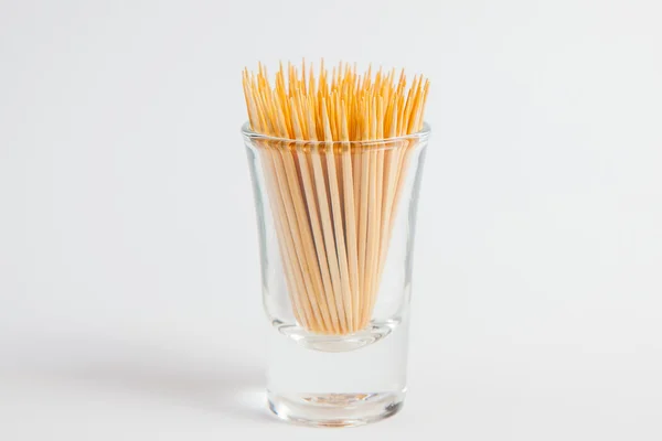 Toothpick in the glass on white paper background — Stock Photo, Image