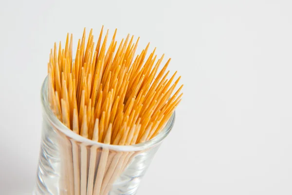 Toothpick in the glass on white paper background — Stock Photo, Image