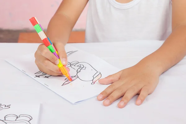 Asian boy Sitting coloring homework. — Stock Photo, Image