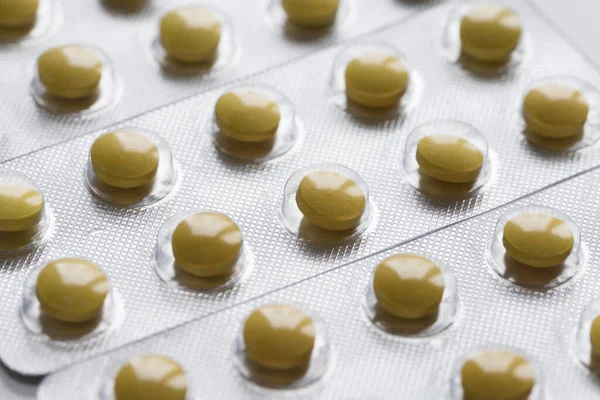 Packagings with yellow pills close up. Production and sale of medical preparations. Cost of the healthy life. Modern healthcare and medicine.