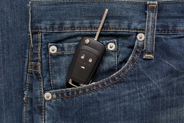 Switch key is lying in side pocket of blue jeans. Modern lifestyle.