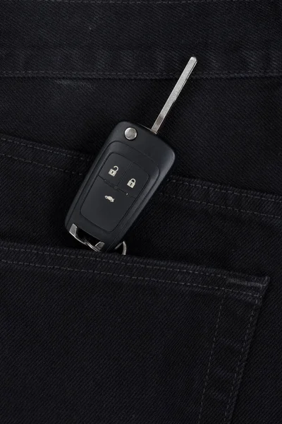 Switch key is lying in side pocket of black pants. Modern lifestyle.