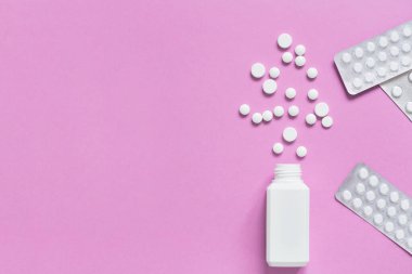 Beyaz haplı ilaç şişeleri, haplı ambalajlar. Tedavi konsepti çeşitli virüsler ve diğer hastalıklar. Pembe arka planda izole edilmiş. Metnin için boşluk kopyala.