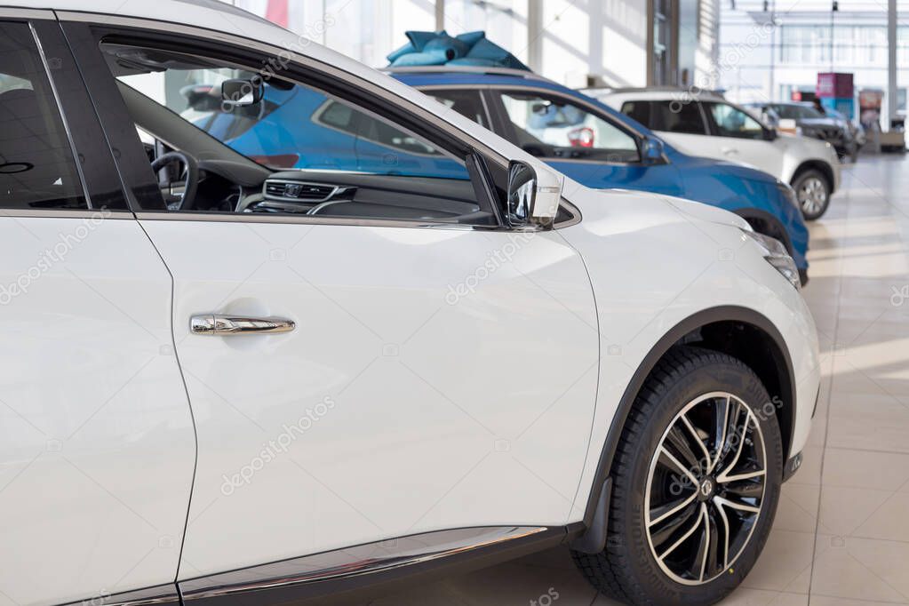 Russia, Izhevsk - February 19, 2021: New modern cars in Nissan showroom. Famous world brand. Prestigious vehicles.