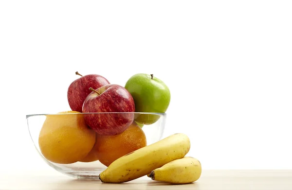Tigela de vidro com frutas para dieta na mesa de madeira — Fotografia de Stock