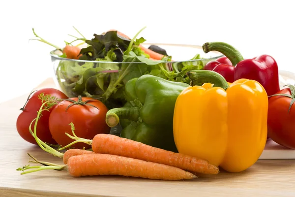 Blandning av grönsaker på sallad på trä bakgrund. Stockbild