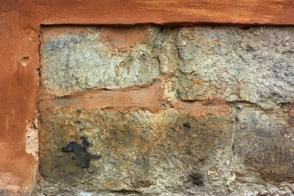 Antiguo muro de piedra con yeso bombardeado —  Fotos de Stock