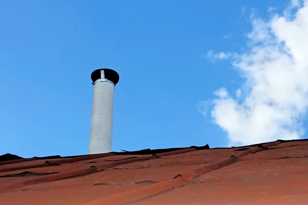 Chimney pipe over the old tinny roof — Stock Photo, Image