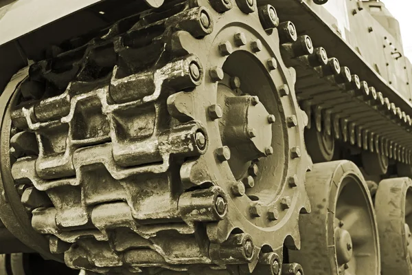 Tracked military equipment close-up, toned