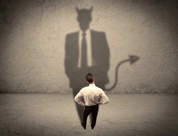 Salesman facing his own devil shadow — Stock Photo, Image
