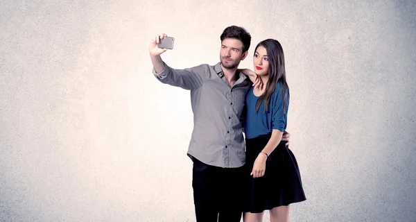 Happy couple taking selfie with clear wall — Stock Photo, Image