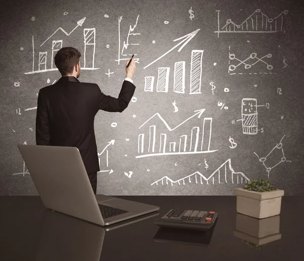 Businessman drawing sales charts on wall — Stock Photo, Image