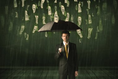 Bir dolar yağmur konseptinde şemsiyesi olan bir iş adamı