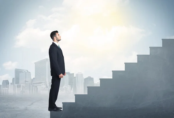 Businessman climbing up a concrete staircase concept — Stock Photo, Image