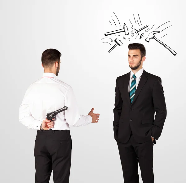 Businessman hiding a weapon — Stock Photo, Image