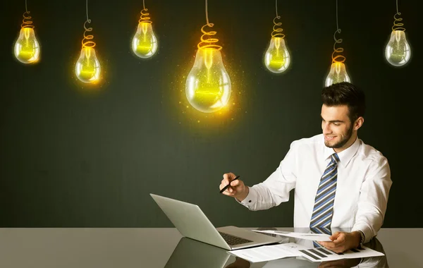 Businessman with idea bulbs — Stock Photo, Image