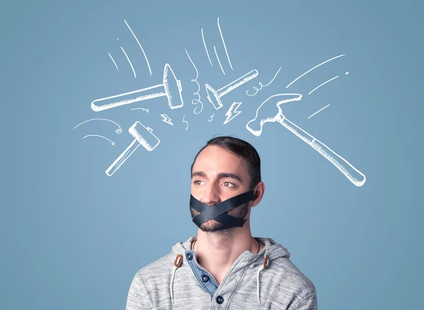 Young man with glued mouth and beating hammer marks — Stock Photo, Image