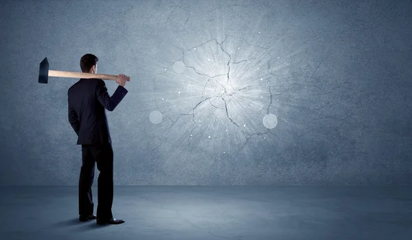 Business man hitting wall with a hammer — Stock Photo, Image