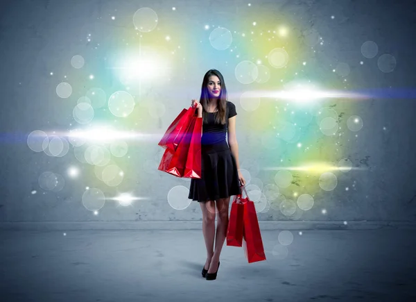Mall κυρία με τσάντες ψώνια και glitter φως — Φωτογραφία Αρχείου