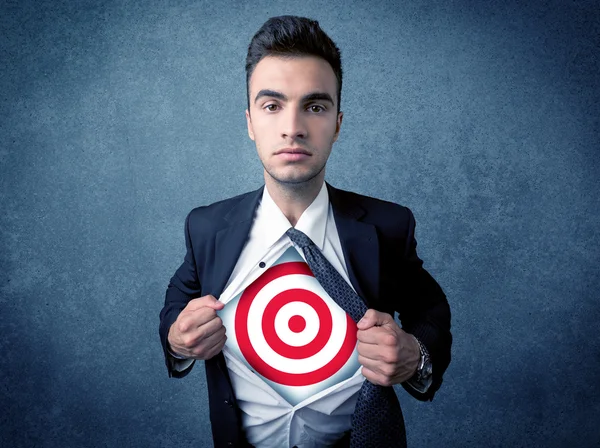 Businessman tearing shirt with target sign on his chest — Stock Photo, Image