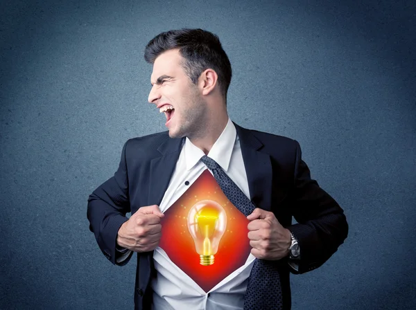 Businessman ripping off shirt and idea light bulb appears