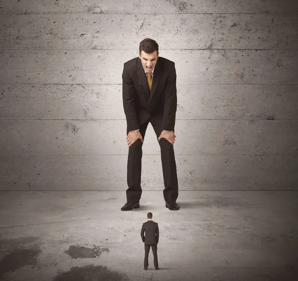 Huge business guy looking at small coworker — Stock Photo, Image