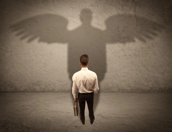Honest salesman with angel shadow concept — Stock Photo, Image