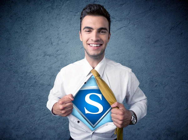 Businessman ripping off his shirt with superhero sign — Stock Photo, Image