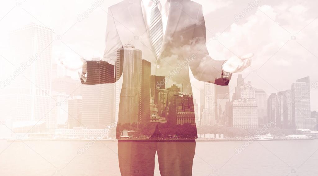 Businessman standing at cityscape background